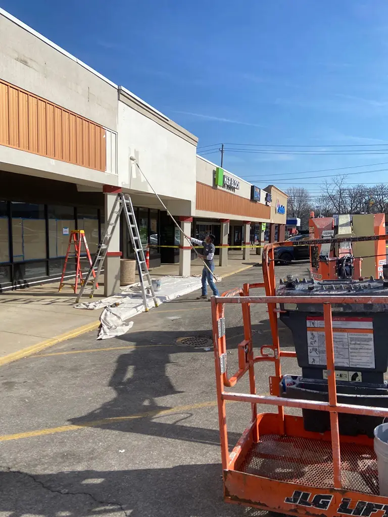 ADA compliant shower with grab bars, handheld showerhead, adjustable wall mount, and built-in corner shelf for accessibility.